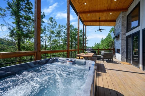 **Unwind in luxury with breathtaking views.** Soak up the serenity in this private hot tub oasis.