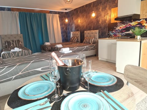 Deluxe Quadruple Room, Garden View | In-room safe, desk, laptop workspace, blackout drapes