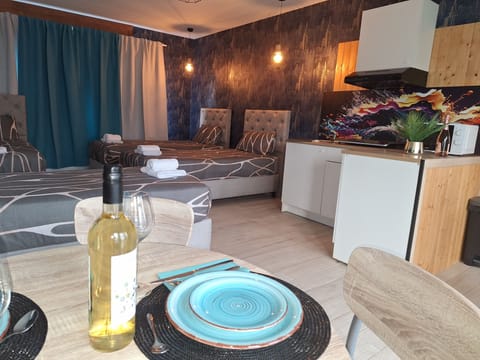 Deluxe Quadruple Room, Garden View | In-room safe, desk, laptop workspace, blackout drapes