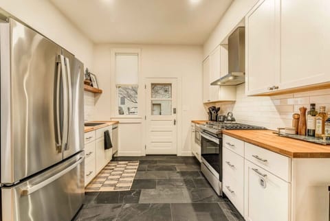 Fully equipped kitchen featuring a large fridge, oven, and stove—perfect for preparing your favorite meals during your stay.