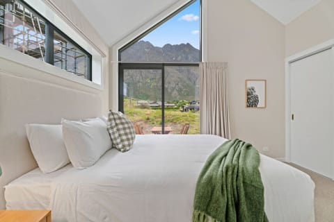 Master bedroom with king size bed and outlook towards The Remarkables.