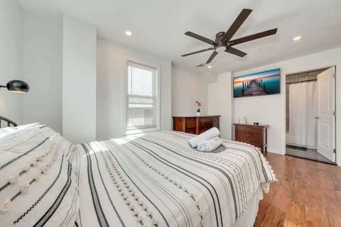 Relax in this bright, comfortable bedroom after a day at the beach.