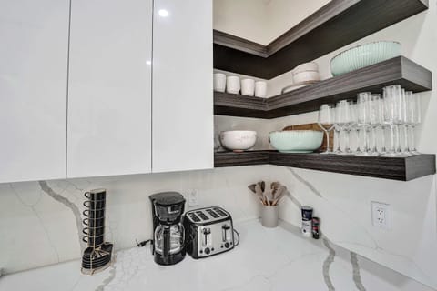 Ample counter space and modern conveniences, including a coffee maker, toaster, and hot water kettle.