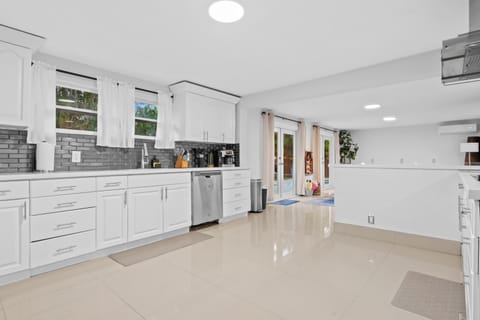 Cook up a storm in this sleek, sunlit kitchen with modern touches and bright vibes!