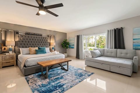 Bedroom Retreat: Relax in style with plush bedding, a chic seating area, and abundant natural light!