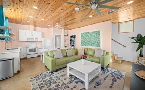 Open Plan Living — Green Leather Sectional, Tropical Palm Art, Pine Ceiling & Kitchen