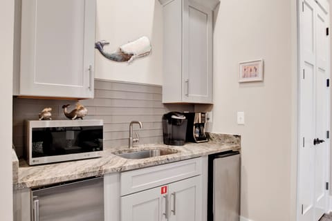 The second floor wet bar with a mini-fridge, ice maker, coffee makers and microwave