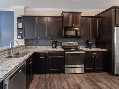 Cook in style with this sleek, modern kitchen featuring top-of-the-line stainless steel appliances.
