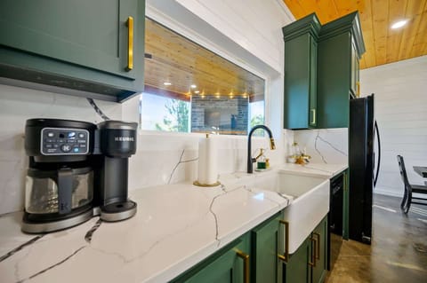 The chic, open kitchen offers ample space & all the comforts of home