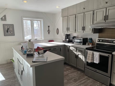 Full kitchen with Nespresso and Keurig machines, pots and pans and more.