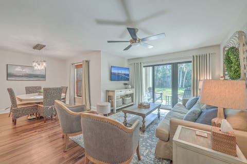 Welcome to this bright and stylish living area with a large slipcovered sofa and sliding door access to the patio.