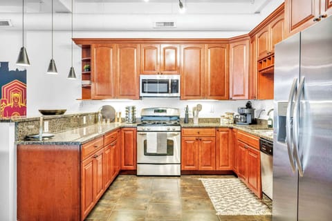 Blend of Elegance and Functionality! Featuring rich wooden cabinetry, top-of-the-line stainless steel, and ample space to keep you inspired.