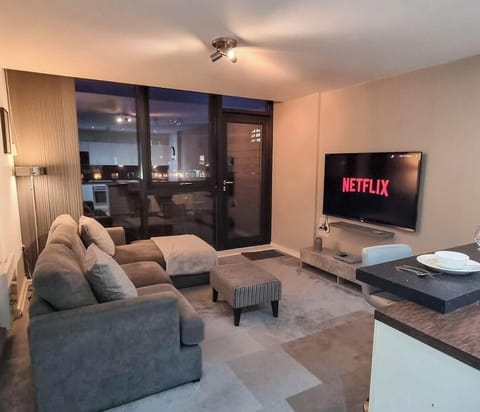 Relax and unwind in this cozy, light-filled living room, perfect for evenings spent lounging with family or friends