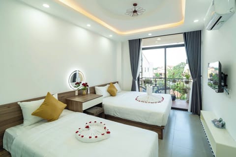 Deluxe Triple Room, Multiple Beds, Balcony, City View | Premium bedding, down comforters, pillowtop beds, free minibar