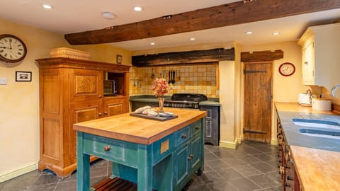 The fridge/freezer is hidden away in a decorative cabinet