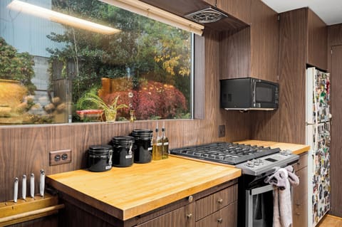 Fully equipped kitchen with a garden view.