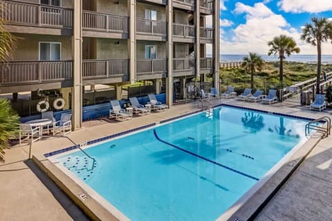 Enjoy the community pool with a beautiful view toward the beach at Sand Dollar Villas.