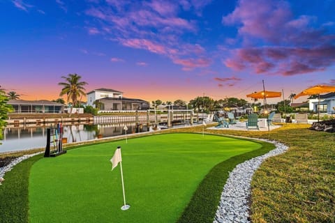 Outdoor Oasis: Enjoy stunning sunset views while practicing your putting skills by the water.