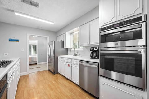 The upper-level’s airy kitchen offers ample space & all the comforts of home