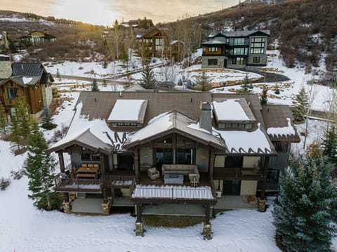Covered deck with patio seating, fire table, dining table and BBQ