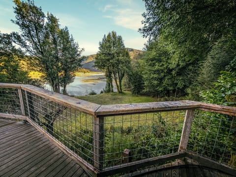 Enjoy a coffee from this wrap-around deck overlooking the Rogue River