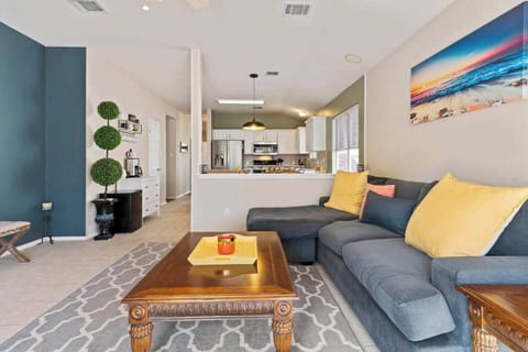 Open-concept living space with sectional sofa and kitchen view