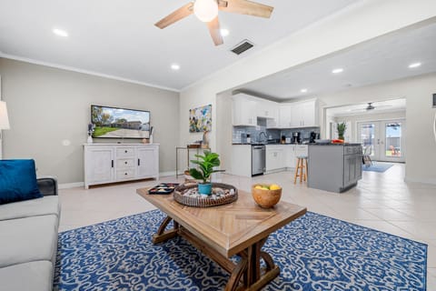 Bright, open living room with comfy seating and smart TV, perfect for unwinding after beach days. #BradentonRental #FamilyStay #FloridaVacation