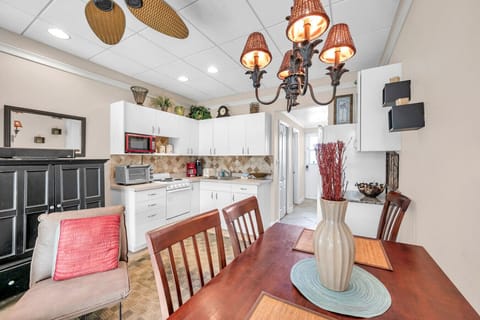 Warm dining area w/ wood table, soft lighting, and easy flow to the living space.