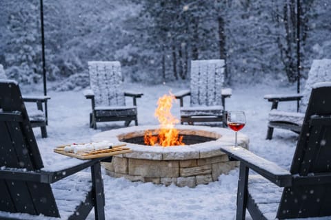 Cozy up by the outdoor firepit with Adirondack chairs, s’mores, wine, and stars.