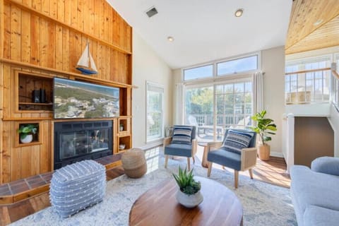 Relax in this bright living space where sunlight streams through floor-to-ceiling windows, warming the wood floors and inviting you to curl up by the fireplace with a good book.