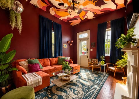 Velvet sectional, ceiling mural, and vintage charm make the perfect pre-Frenchmen Street lounge.