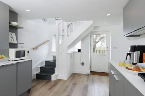 The entrance into the kitchen with stairs leading to the first floor