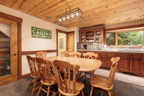 Gather around this warm wooden dining table where mountain adventures are planned and memories shared over home-cooked meals.