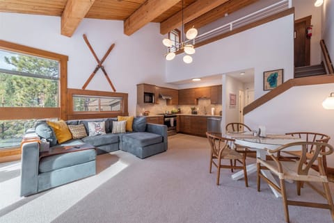 Step into your bright, airy mountain retreat where rustic wood beams frame soaring ceilings and natural light floods through expansive windows. You'll love the open-concept design connecting your cozy living area to a fully equipped kitchen.