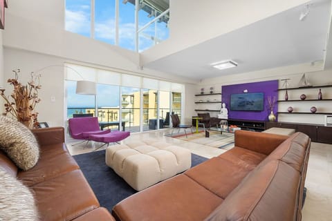 This expansive living room boasts an open layout with abundant natural light, creating a warm and inviting atmosphere. Perfect for both relaxing and entertaining, it offers plenty of space to personalize and make it your own.