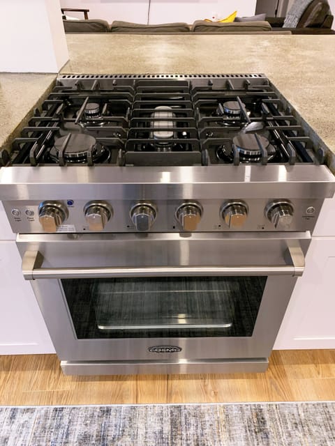 Enjoy cooking on the pro-style, five burner gas range with oven.