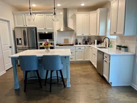 New Kitchen with 5 top gas stove. Wall mounted oven and microwave, dishwasher 