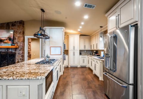 This spacious kitchen is both stylish and functional, offering high-end finishes, generous counter space, and plenty of storage to make cooking enjoyable and effortless.