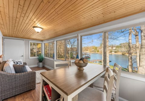 Sun room with high top table for 4 and a couch to enjoy the lake views. 