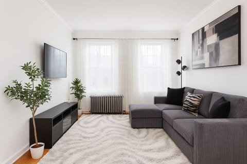 Bright living room with cozy sofa-bed and natural light”