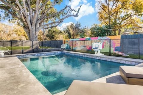 Heated outdoor pool with basketball hoop and plenty of lounge chairs!