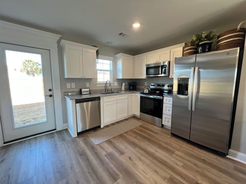 Well-Equipped Kitchen with natural light from back door of home