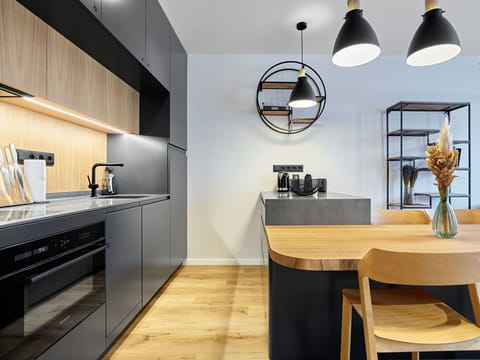Furniture, Interior Design, Kitchen, Wall, Flooring, Countertop, Light Fixture, Wood, Cabinetry, Ceiling