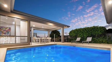 Enjoy a refreshing swim or relax in the private heated pool, nestled among lush greenery.