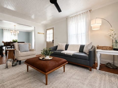 Top grain leather sofa, gorgeous hide ottoman, and side chair in the living room with big screen smart TV and electric fireplace.