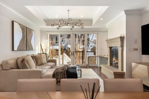 Spacious living area with floor to ceiling windows, comfortable seating, smart TV and gas fireplace