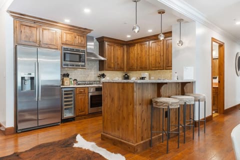 Fully stocked kitchen with wine cooler and bar seating