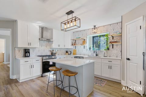 Whip up delicious meals with a view! This bright and airy kitchen offers everything you need to create culinary delights, including a spacious island and a lovely view from the window.