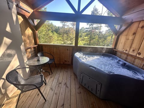 Cozy  porch with relaxing hot tub and forest views