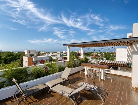 Shared rooftop terrace with sun loungers